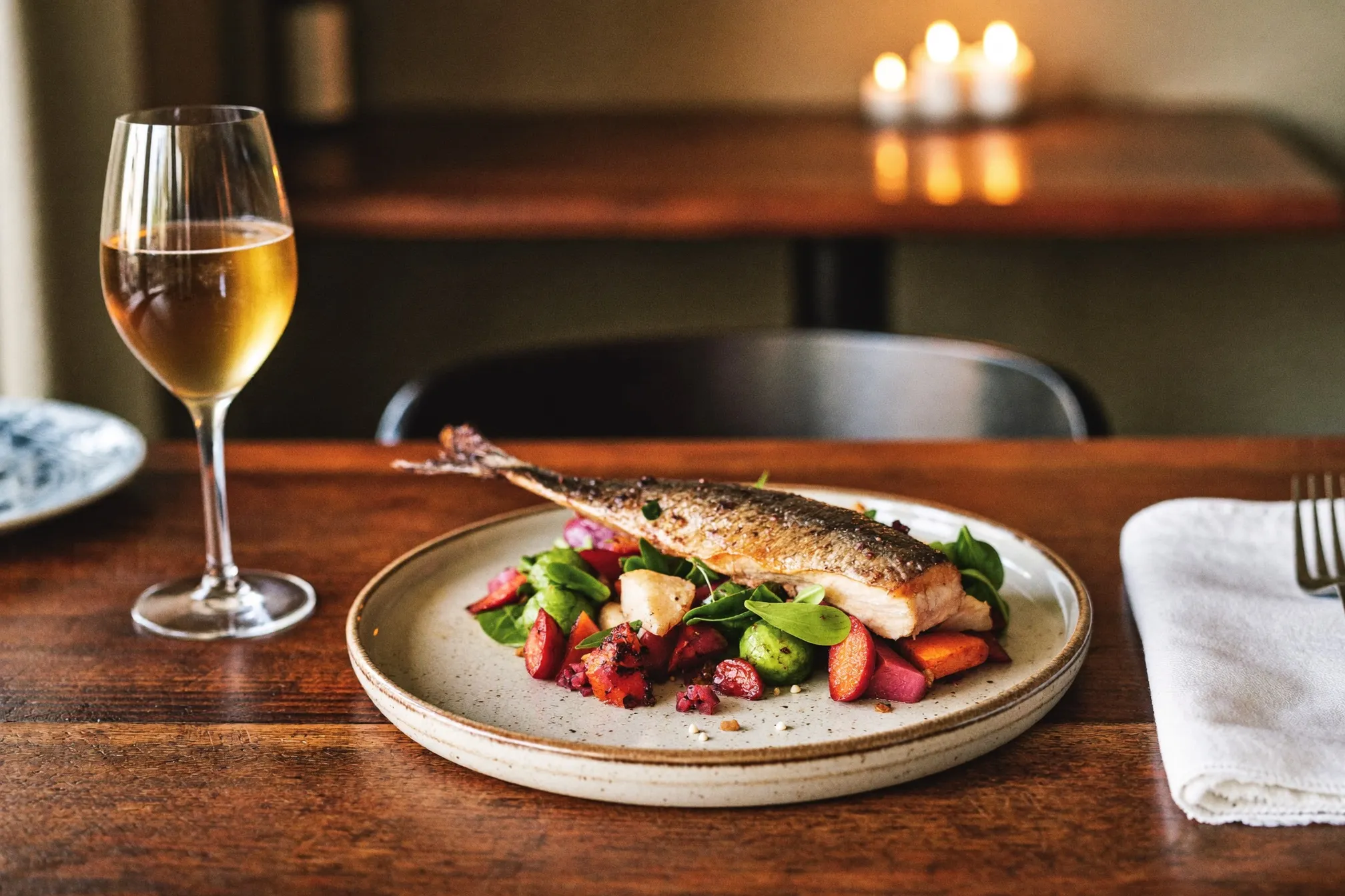 Farm-to-table dish plated on handmade ceramic in a warm Central New York bistro
